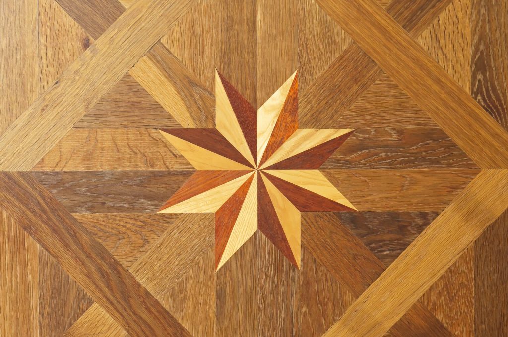 Decorative star at hard wood parquet floor