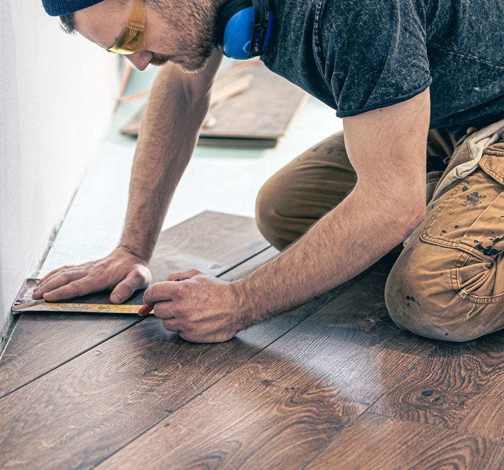 male-worker-puts-laminate-flooring-floor